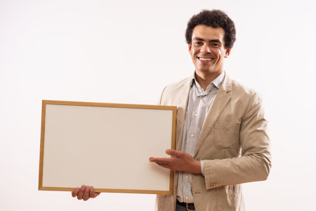 Portrait of businessman showing whiteboard.の写真素材