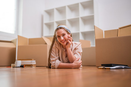 Modern ginger woman with braids moving into new apartment.の写真素材