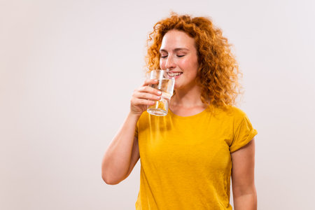 Image of beautiful ginger woman drinking water.の写真素材