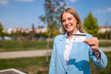Portrait of beautiful businesswoman holding credit card.の写真素材