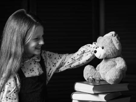 The girl is happy about the teddy bear.の写真素材