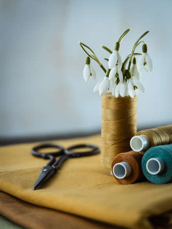 Spring flowers on a seamstress' s work desk.の写真素材