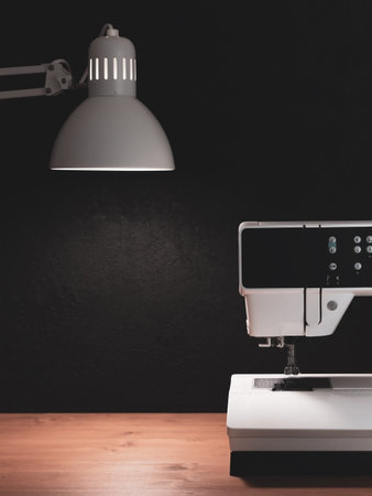 Tailor's desk, sewing machine and lighting.