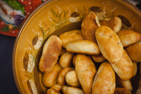 Round brown bowl with hot piesの写真素材