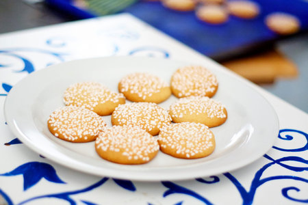 Light brown cookies with white sugar grains on a white plate