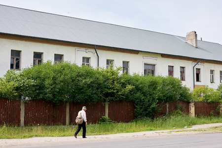 walker with a backpack going down the street in Liepaja, Latviaの写真素材