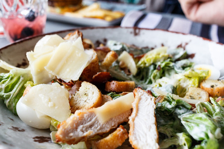 Caesar salad in a round plateの写真素材