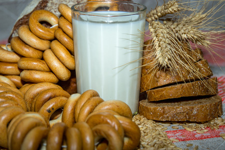 A glass of milk with bagelsの写真素材