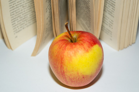 Apple on the background of the book.の写真素材