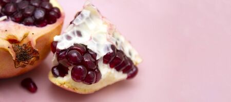 juicy sweet pomegranate on a pink background. vitamin-rich foods. layout for the text.の写真素材