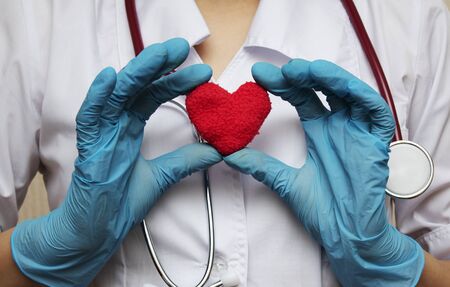 doctor with a heart in his hands in the hospital. The concept of healthの写真素材