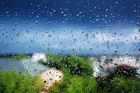 drops on the glass after rain, beautiful background, the concept of home comfort, cleaning and...