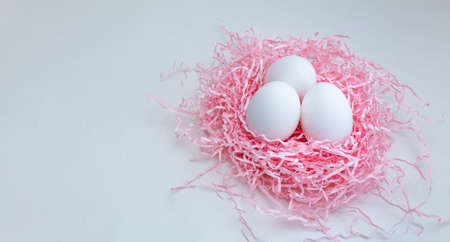 pastel Easter composition, eggs in a decorative nest on a pink background,の写真素材