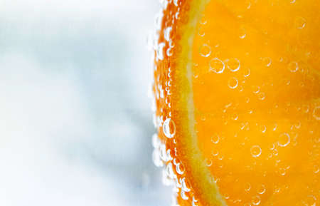 orange in water with bubbles, layout with space for text.の写真素材