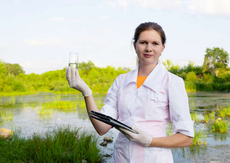 a young attractive female biologist working on water analysis, the concept of ecologyの写真素材