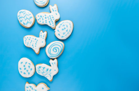 gingerbread in glaze on a blue background, Easter layout with copy space