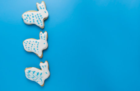 gingerbread in glaze on a blue background, Easter layout with copy spaceの写真素材