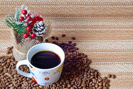 A Cup of coffee and scattered around the coffee beans.の写真素材