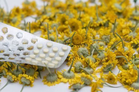 Packaging of tablets against the background of daisies.の写真素材