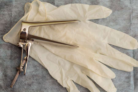 Sterile medical instrument for gynecological examination and gloves.の写真素材