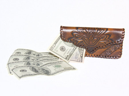 Worth female brown purse with several protruding bills, and next are a few dollar bills