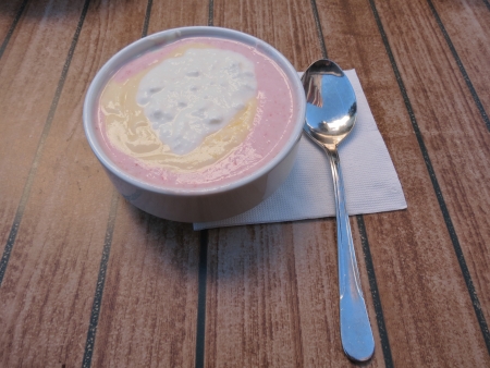  On the table is a plate with fruit and yogutom lying side by side on a napkin spoon                              の写真素材