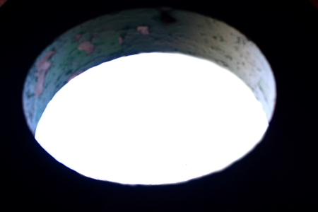 Against the sky shows a round hole in the wallの写真素材