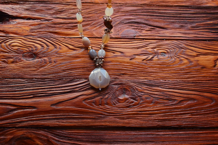 on a wooden board part of women's necklacesの写真素材
