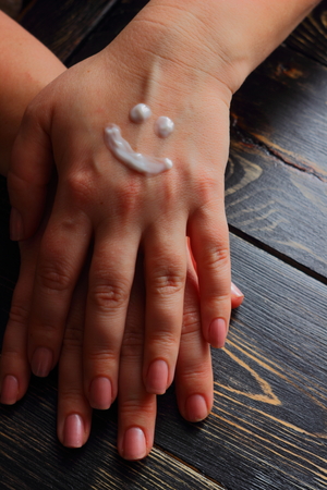 on the hand cream is applied smileyの写真素材
