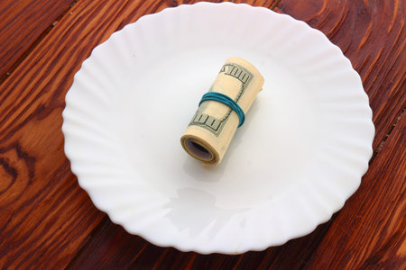 dollars twisted rubber band lying on a plate