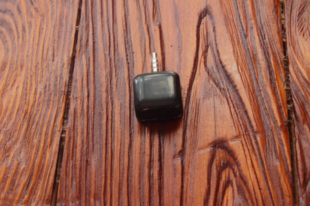 on a wooden board is an adapter for receiving a card payments via phone