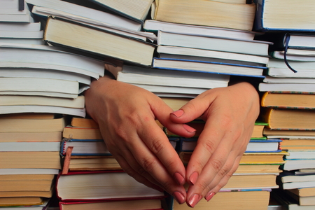 is a stack of books and hanging armsの写真素材