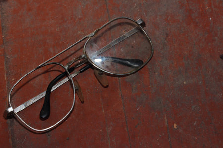 lie on a wooden board old broken glassesの写真素材