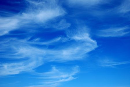 Beautiful, white, fluffy clouds against the blue sky before sunsetの写真素材