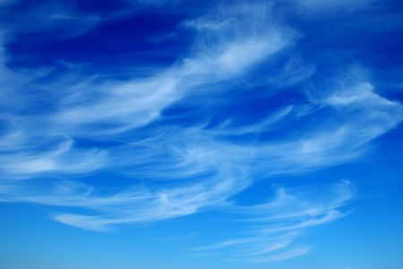 Beautiful, white, fluffy clouds against the blue sky before sunsetの写真素材