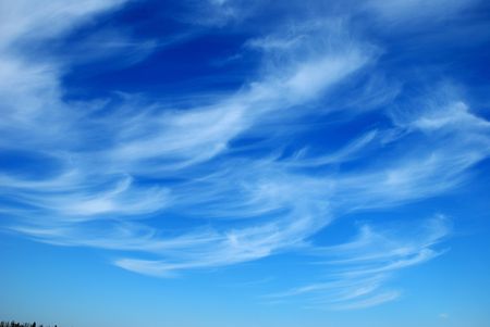 Beautiful, white, fluffy clouds against the blue sky before sunsetの写真素材