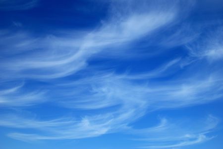 Beautiful, white, fluffy clouds against the blue sky before sunsetの写真素材
