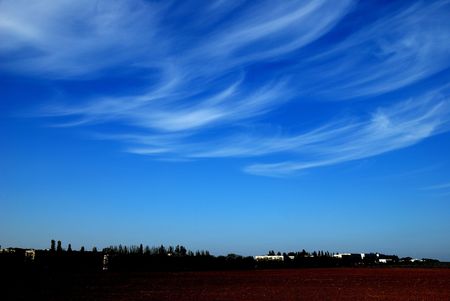Beautiful, white, fluffy clouds against the blue sky before sunsetの写真素材