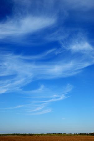 Beautiful, white, fluffy clouds against the blue sky before sunsetの写真素材