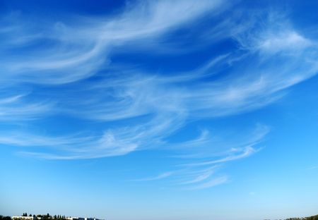 Beautiful, white, fluffy clouds against the blue sky before sunsetの写真素材