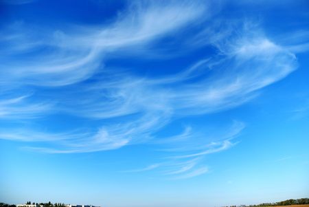 Beautiful, white, fluffy clouds against the blue sky before sunsetの写真素材