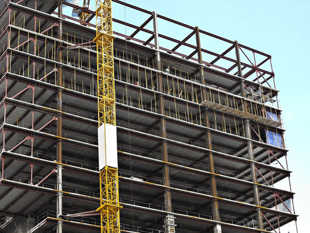 Workmen building a tall urban structure