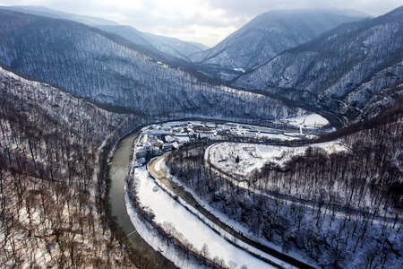 Aerial drone photo of a beautiful monastery in Romania set in a charming winter landscape with snowの写真素材