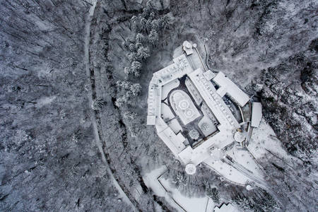 Aerial drone photo of a beautiful monastery in Romania set in a charming winter landscape with snowの写真素材