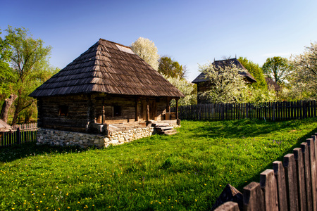 Small wooden cottage with old traditional rustic architecture in the countryside of Romaniaの写真素材