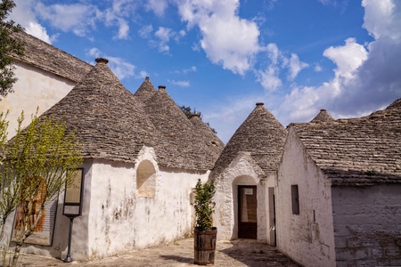 Amazing architecture in the Italian destination of Alberobello with the typical conical stone roofs and white wallsの写真素材