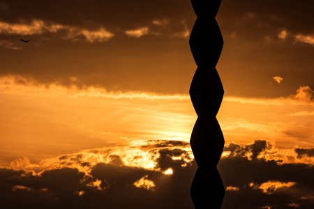 The famous Endless Column monument by Constantin Brancusi on a golden sunset backgroundの写真素材