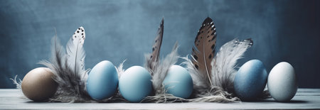 Easter eggs and feathers on a blue background. Toned.の素材