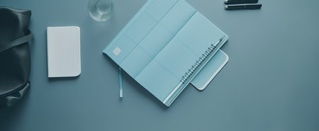 Top view of office desk with notepad, smartphone and coffee cupの素材