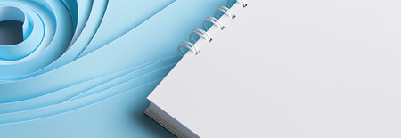 Paper spiral notebook on blue paper background. 3d render illustration.の素材